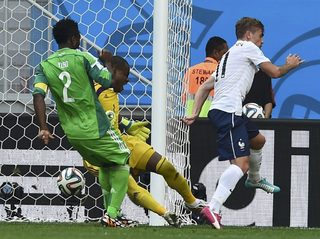 Nigeria's Yobo kicks the ball and scores an own goal beside teammate Enyeama and France's Griezmann during their 2014 World Cup round of 16 game at the Brasilia national stadium in Brasilia;Nigeria's Yobo kicks the ball and scores an own goal beside teammate Enyeama and France's Griezmann during their 2014 World Cup round of 16 game at the Brasilia national stadium in Brasilia