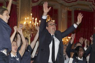 French President Hollande reacts as France team scores a goal against Nigeria, at the Elysee Palace in Paris