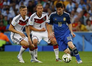 Argentina's Messi fights for the ball with Germany's Kroos and Hoewedes during their 2014 World Cup final at the Maracana stadium in Rio de Janeiro