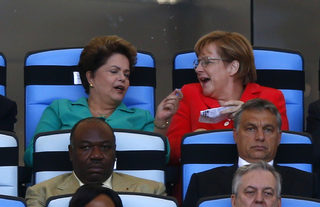 Brazil's President Dilma Rousseff and Germany's Chancellor Angela Merkel chat as they watch the 2014 World Cup final at the Maracana stadium in Rio de Janeiro