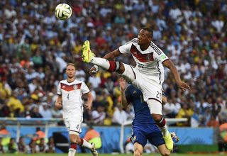Germany's Boateng jumps to kick the ball in front of Argentina's Messi during their 2014 World Cup final at the Maracana stadium in Rio de Janeiro