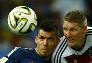 Argentina's Aguero jumps for the ball with Germany's Schweinsteiger during their 2014 World Cup final at the Maracana stadium in Rio de Janeiro