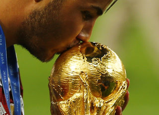 Germany's Mario Goetze kisses the World Cup trophy as he celebrates their 2014 World Cup final win against Argentina at the Maracana stadium in Rio de Janeiro