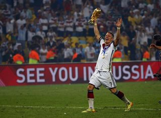 Germany's Bastian Schweinsteiger holds the World Cup trophy as he celebrates their 2014 World Cup final win against Argentina at the Maracana stadium in Rio de Janeiro