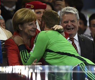 Germany's goalkeeper Neuer receives a hug from Chancellor Merkel beside President Gauck after the 2014 World Cup final between Germany and Argentina at the Maracana stadium in Rio de Janeiro