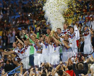 Germany's players lift the World Cup trophy as they celebrate their 2014 World Cup final win against Argentina at the Maracana stadium in Rio de Janeiro