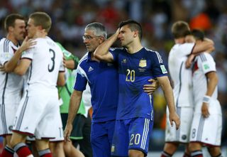 Germany's players celebrate winning as Argentina's Sergio Aguero cries after their 2014 World Cup final at the Maracana stadium in Rio de Janeiro