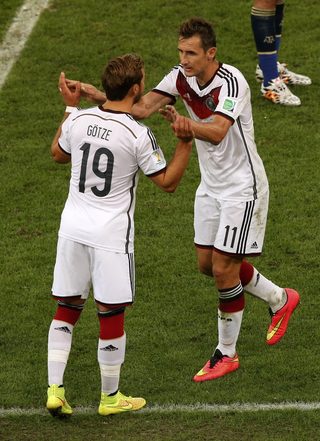 Germany's Mario Goetze goes on as Germany's Miroslav Klose is substituted during their 2014 World Cup final against Argentina at the Maracana stadium in Rio de Janeiro