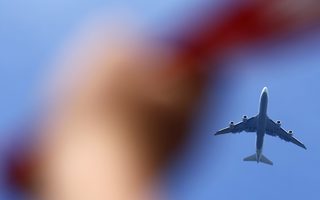 Fans cheer as plane carrying German national soccer team flies over 'fan mile' public viewing zone before landing in Berlin