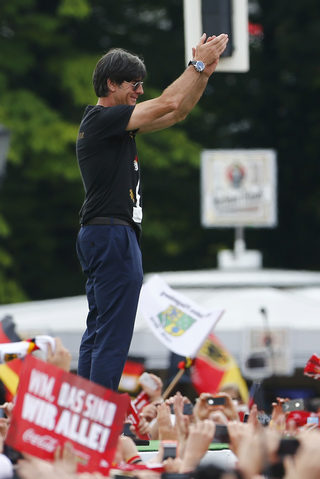 Germany's coach Loew applauds fans during celebrations to mark team's 2014 Brazil World Cup victory at a 'fan mile' public viewing zone in Berlin