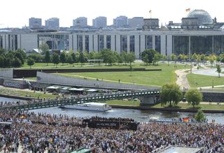 Fans throng street along Spree river to cheer Germany's 2014 Brazil World Cup squad during a parade to mark team's victory in Berlin