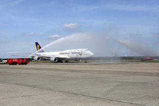 A plane with German national soccer team aboard receives water salute after landing at Tegel airport in Berlin