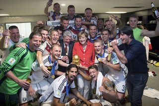 German Chancellor Merkel and German President Gauck pose with the Germany's coach Loew and his players after Germany beat Argentina in the 2014 World Cup final at the Maracana stadium in Rio de Janeiro
