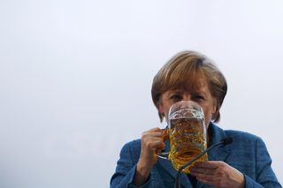 File photo of German Chancellor Merkel drinking a beer after her speech in a beer tent in Munich