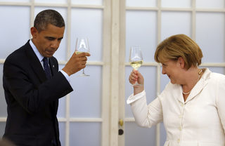 File photo of German Chancellor Merkel and U.S. President Obama raising their glasses in a toast during a dinner at the Chralottenburg Castle in Berlin