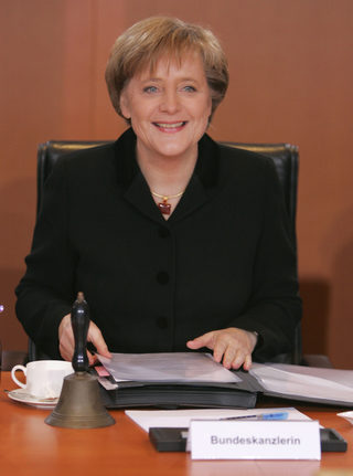 File photo of German Chancellor Angela Merkel sitting in the chancellors seat during first cabinet meeting in Berlin