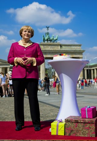 Madame Tussauds wax figure of Chancellor Angela Merkel stands in front Brandenburg Gate in Berlin