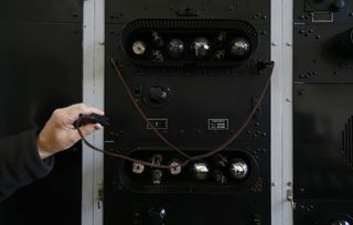 A man shows a radio station facility inside a building of Gliwice radio station
