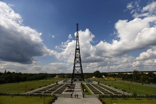 People walk in park in front of the Gliwice radio tower