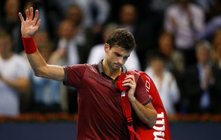 Dimitrov of Bulgaria leaves after losing his match against Federer of Switzerland at the Swiss Indoors ATP tennis tournament in Basel