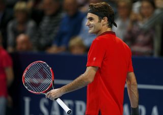 Federer of Switzerland smiles after winning his match against Dimitrov of Bulgaria at the Swiss Indoors ATP tennis tournament in Basel