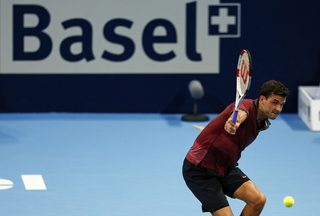 Grigori Dimitrov of Bulgaria returns the ball to Roger Federer of Switzerland at the Swiss Indoors ATP tennis tournament in Basel