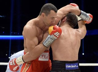 Ukrainian heavyweight boxing world champion Klitschko delivers a punch to his challenger Bulgarian Pulev during their title fight in Hamburg