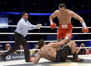 Ukrainian heavyweight boxing world champion Klitschko knocks down his challenger Bulgarian Pulev during their title fight in Hamburg