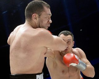 Ukrainian heavyweight boxing world champion Klitschko delivers a punch to his challenger Bulgarian Pulev during their title fight in Hamburg