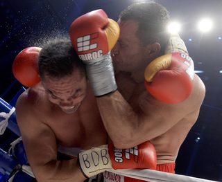 Ukrainian heavyweight boxing world champion Klitschko delivers a punch to his challenger Bulgarian Pulev during their title fight in Hamburg