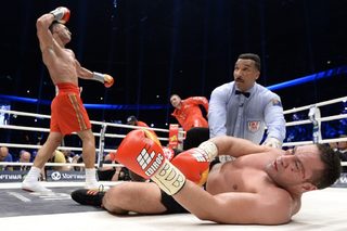 Challenger Bulgarian heavyweight boxer Pulev lies in the ring after being knocked down by Ukrainian WBA, WBO, IBO and IBF heavyweight boxing world champion Klitschko after their title fight in Hamburg