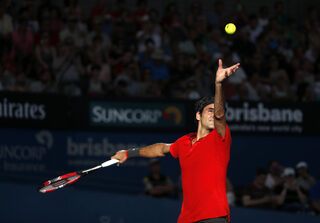 Federer of Switzerland serves during his men's singles semi final win over Dimitrov of Bulgaria at the Brisbane International tennis tournament in Brisbane