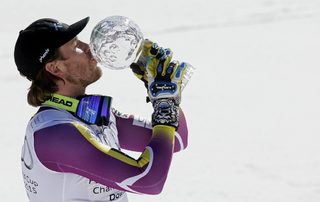 Jansrud of Norway kisses the Globe after winning the World Cup downhill trophy in the men's downhill race at the Alpine Skiing World Cup Finals in Meribel