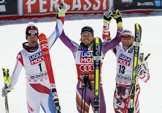 Jansrud of Norway celebrates with second placed Defago of Switzerland and third placed Streitberger of Austria, after winning the World Cup downhill trophy in the men's downhill race at the Alpine Skiing World Cup Finals in Meribel