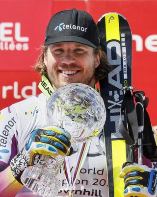 Jansrud of Norway poses with his Globe after winning the World Cup downhill trophy in the men's downhill race at the Alpine Skiing World Cup Finals in Meribel