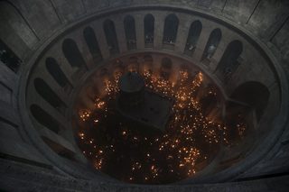 Worshippers hold candles as they take part in the Christian Orthodox Holy Fire ceremony at the Church of the Holy Sepulchre in Jerusalem's Old City