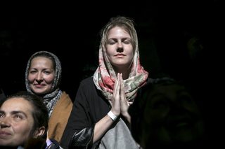 A worshipper prays during the Holy Fire ceremony at the Church of the Holy Sepulchre in Jerusalem's Old City