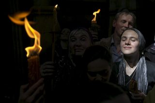 A worshipper prays during the Holy Fire ceremony at the Church of the Holy Sepulchre in Jerusalem's Old City