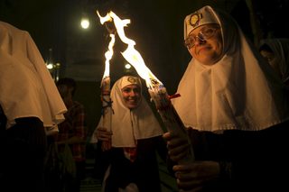 Christian Orthodox nuns hold candles during the Holy Fire ceremony at the Church of the Holy Sepulchre in Jerusalem's Old City