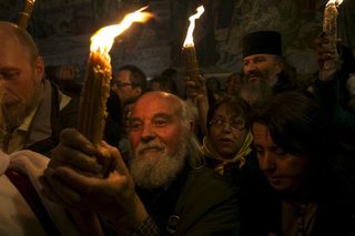 Worshippers hold candles as they take part in the Christian Orthodox Holy Fire ceremony at the Church of the Holy Sepulchre in Jerusalem's Old City