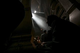 A Christian Orthodox nun holds a candle as she takes part in the Holy Fire ceremony at the Church of the Holy Sepulchre in Jerusalem's Old City