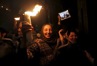 Worshippers hold candles as they take part in the Christian Orthodox Holy Fire ceremony at the Church of the Holy Sepulchre in Jerusalem