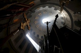 Worshippers hold candles as they take part in the Christian Orthodox Holy Fire ceremony at the Church of the Holy Sepulchre in Jerusalem