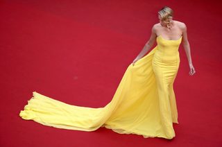 Cast member Charlize Theron poses on the red carpet as she arrives for the screening of the film "Mad Max: Fury Road" out of competition at the 68th Cannes Film Festival in Cannes