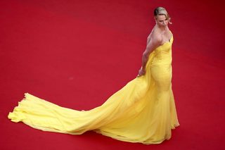 Cast member Charlize Theron poses on the red carpet as she arrives for the screening of the film "Mad Max: Fury Road" out of competition at the 68th Cannes Film Festival in Cannes