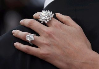 Rings are seen on the fingers of cast member Charlize Theron as she poses on the red carpet for the screening of the film "Mad Max: Fury Road" out of competition at the 68th Cannes Film Festival in Cannes