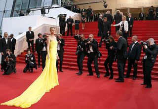 Cast member Charlize Theron poses on the red carpet as she arrives for the screening of the film "Mad Max: Fury Road" out of competition at the 68th Cannes Film Festival in Cannes