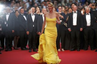 Cast member Charlize Theron poses on the red carpet as she arrives for the screening of the film "Mad Max: Fury Road" out of competition at the 68th Cannes Film Festival in Cannes