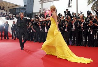 Cast member Charlize Theron and actor Sean Penn pose on the red carpet as they arrive for the screening of the film "Mad Max: Fury Road" out of competition at the 68th Cannes Film Festival in Cannes