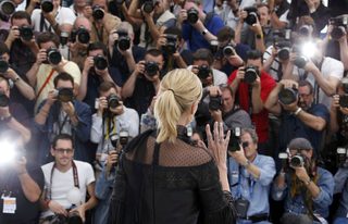 Cast member Charlize Theron poses during a photocall for the film "Mad Max: Fury Road" out of competition at the 68th Cannes Film Festival in Cannes
